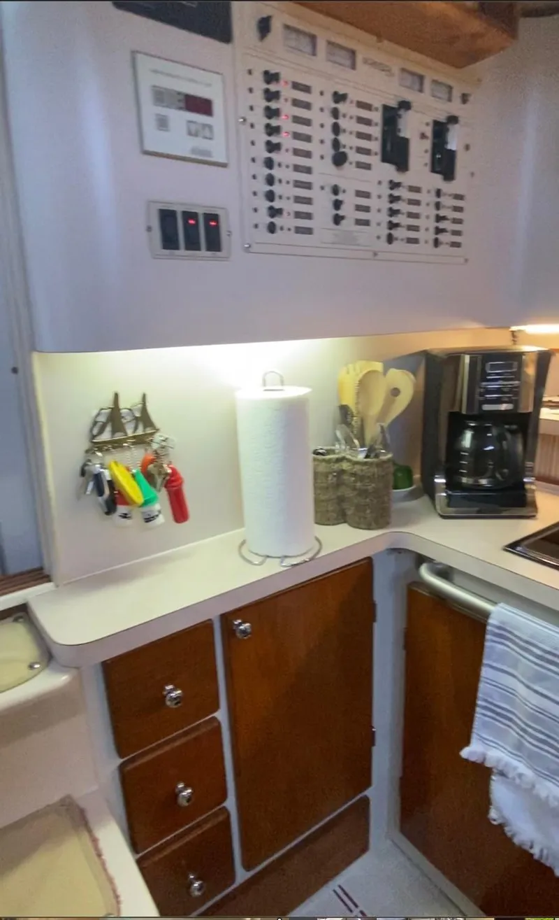 Slide: The Image of 1992 Regal Commodore 400 yacht kitchen with control panel, coffee maker, and utensils. - 7