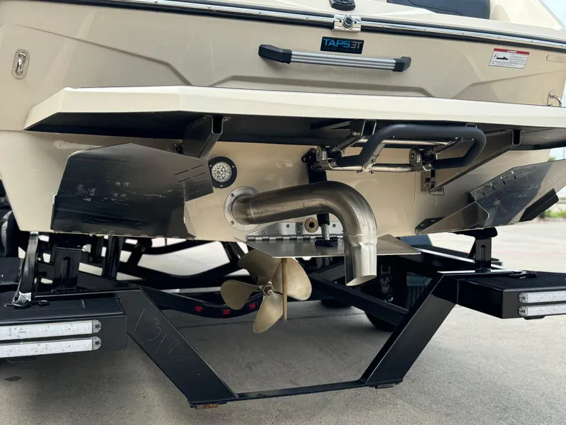 Slide: The Image of 2024 ATX Surf Boats 22 Type-S rear view, showcasing propeller and exhaust system. - 5