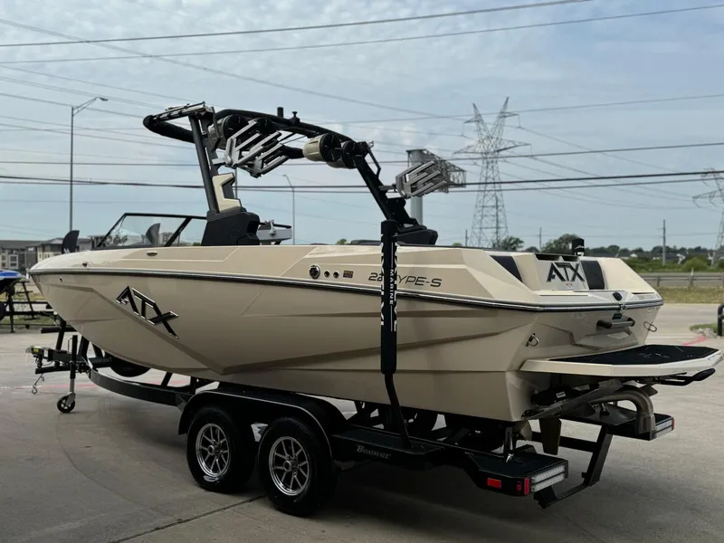 Slide: The Image of 2024 ATX Surf Boats 22 Type-S on trailer, beige color, parked outdoors. - 6
