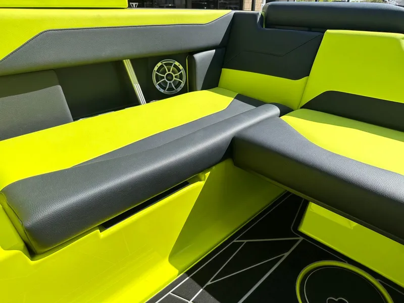 Slide: The Image of 2024 ATX Surf Boats 22 Type-S interior with vibrant lime green and black seating. - 11