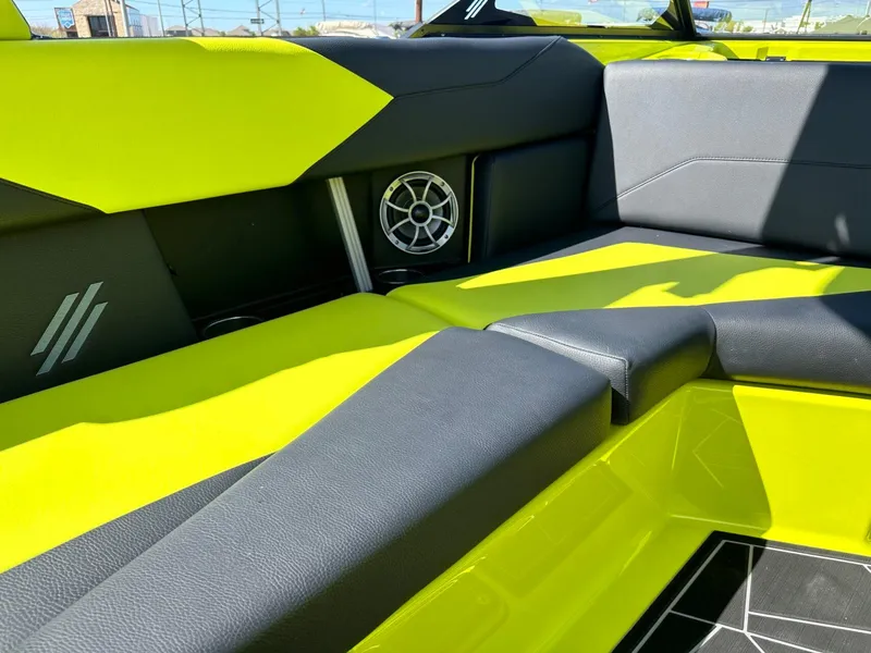 Slide: The Image of 2024 ATX Surf Boats 22 Type-S interior with vibrant lime and black seating. - 14