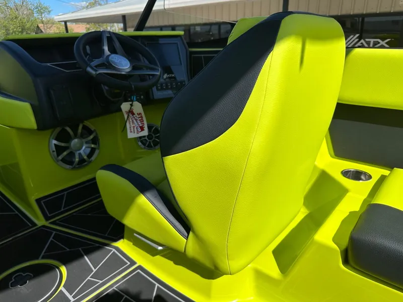 Slide: The Image of 2024 ATX Surf Boats 22 Type-S interior with vibrant lime green seating and dashboard. - 16