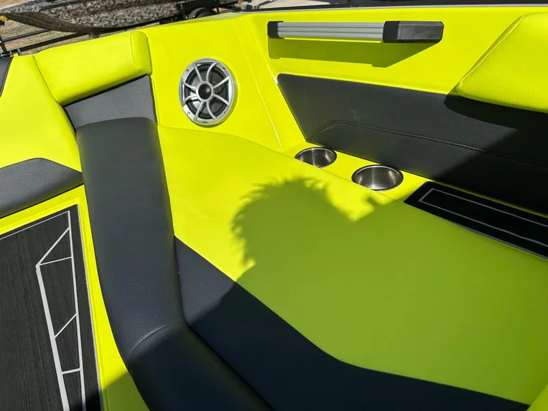 Slide: The Image of 2024 ATX Surf Boats 22 Type-S interior with vibrant yellow seating and cup holders. - 20