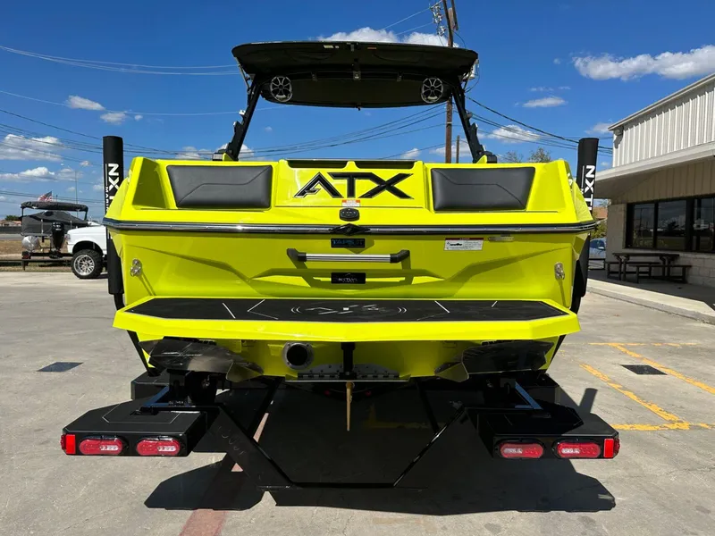 Slide: The Image of 2024 ATX Surf Boats 22 Type-S in vibrant yellow, rear view in a parking lot. - 3