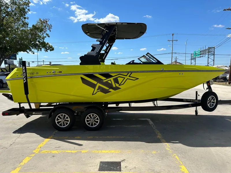 Slide: The Image of 2024 ATX Surf Boats 22 Type-S in vibrant yellow on trailer, side view. - 5