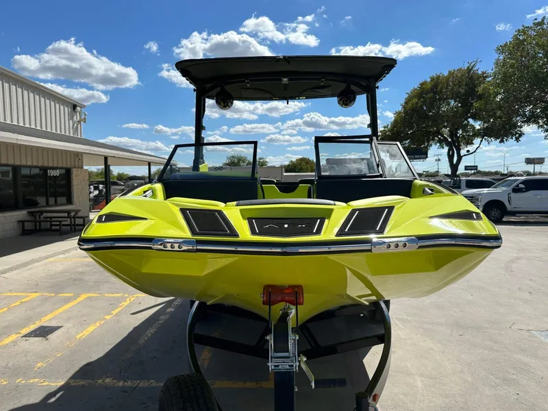 Slide: The Image of 2024 ATX Surf Boats 22 Type-S in vibrant green on a trailer, sunny day. - 7