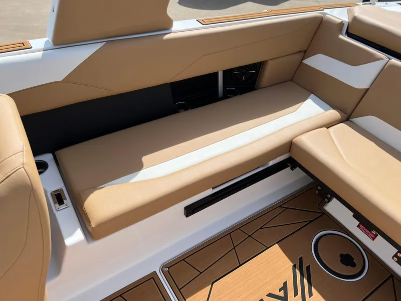 Slide: The Image of 2024 ATX Surf Boats 24 Type-S interior with tan and white seating. - 10