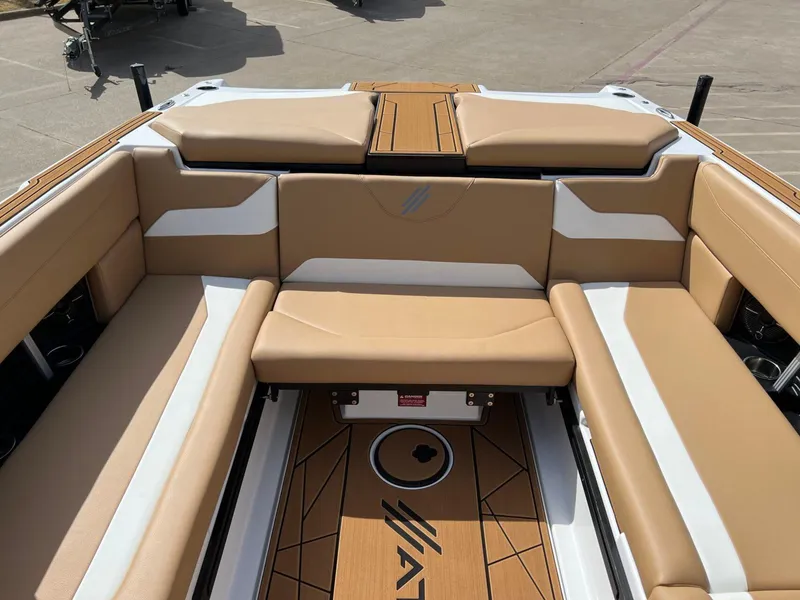 Slide: The Image of 2024 ATX Surf Boats 24 Type-S interior with tan and white seating. - 11