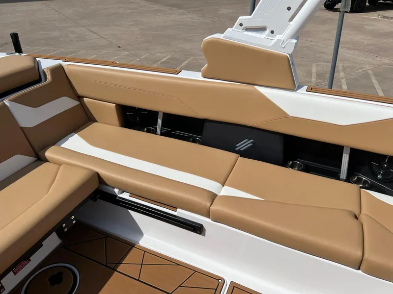 Slide: The Image of 2024 ATX Surf Boats 24 Type-S interior with tan and white seating. - 12