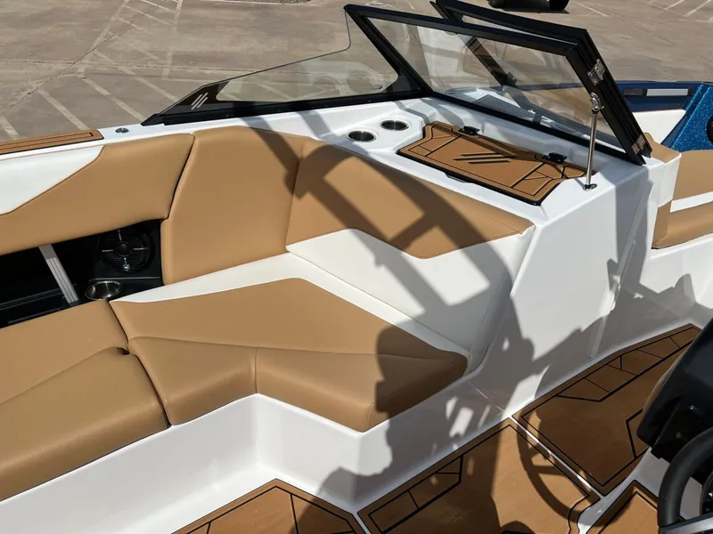 Slide: The Image of 2024 ATX Surf Boats 24 Type-S interior with tan and white seating, modern dashboard. - 14