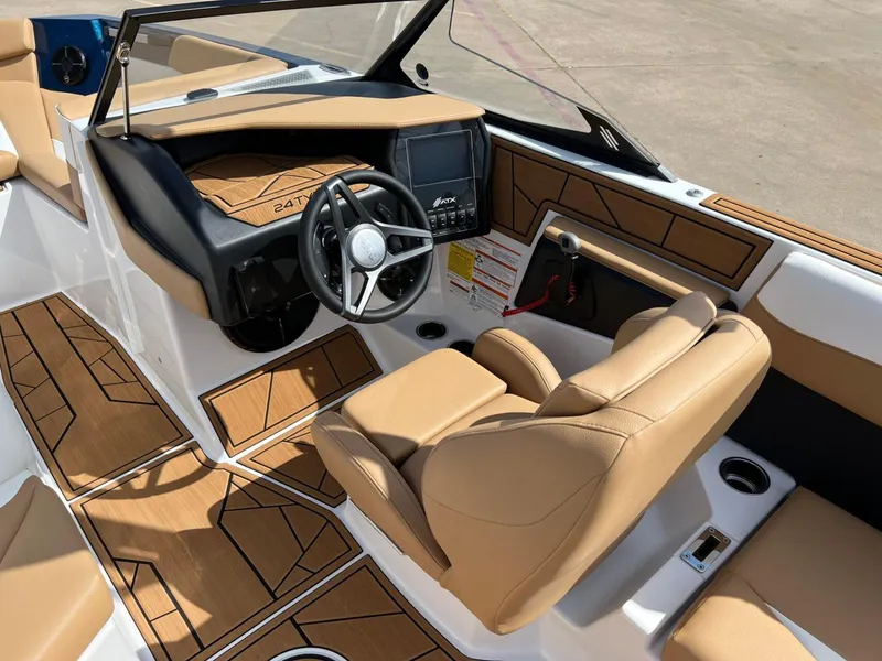 Slide: The Image of 2024 ATX Surf Boats 24 Type-S interior with tan seating and modern dashboard. - 15