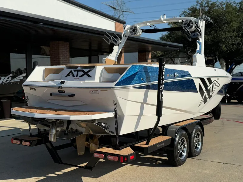 Slide: The Image of 2024 ATX Surf Boats 24 Type-S on trailer, featuring sleek design and vibrant blue accents. - 4