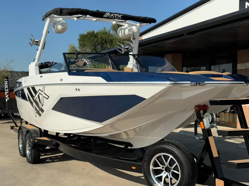 Slide: The Image of 2024 ATX Surf Boats 24 Type-S on trailer, sleek design, parked outdoors. - 5