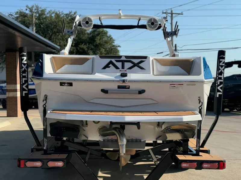 Slide: The Image of 2024 ATX Surf Boats 24 Type-S on trailer, rear view with NXT LVL Marine branding. - 6