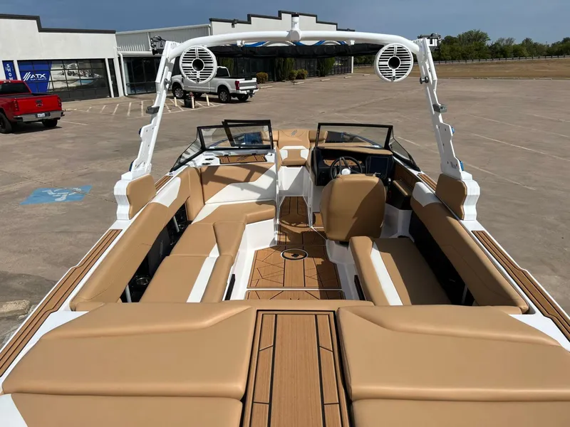 Slide: The Image of 2024 ATX Surf Boats 24 Type-S with tan interior, parked in a lot. - 8