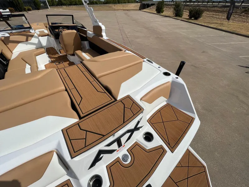 Slide: The Image of 2024 ATX Surf Boats 24 Type-S interior with tan and white seating, wood accents. - 9