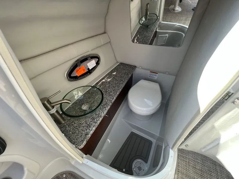 Slide: The Image of 2024 Crownline 270 SS boat bathroom with modern sink and toilet. - 11