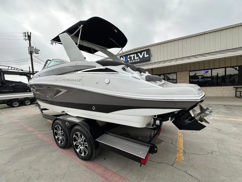 Slide: The Image of 2024 Crownline 270 SS boat on trailer at dealership, showcasing sleek design and modern features. - 18