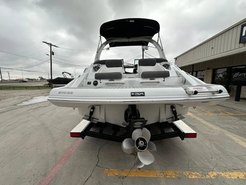 Slide: The Image of 2024 Crownline 270 SS boat rear view with dual propellers and seating. - 19