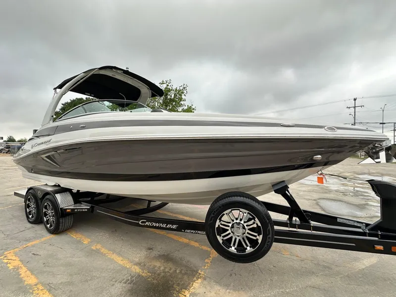 Slide: The Image of 2024 Crownline 270 SS boat on trailer, overcast sky background. - 22