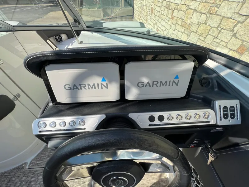 Slide: The Image of 2024 Crownline 270 SS dashboard with dual Garmin displays and control panel. - 8