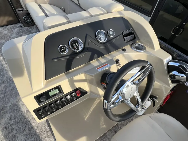 Slide: The Image of 2023 Crest Classic LX 220 SLS boat dashboard with steering wheel and control panel. - 14