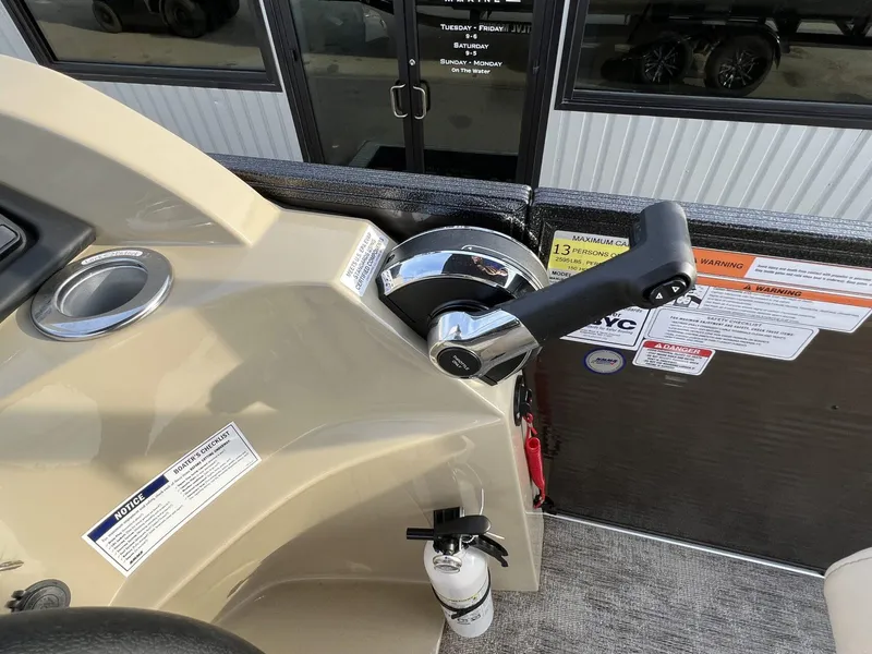 Slide: The Image of Control panel of 2023 Crest Classic LX 220 SLS boat with throttle and safety labels. - 15