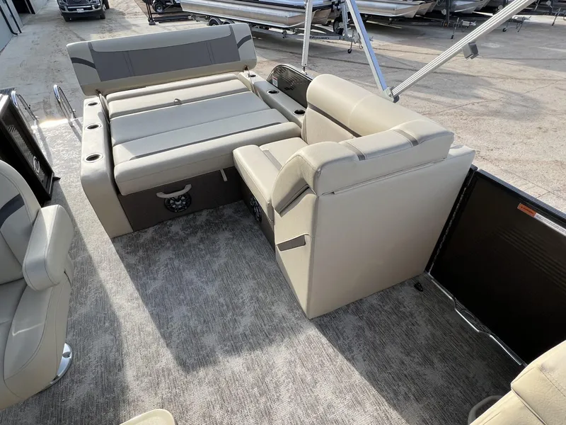 Slide: The Image of 2023 Crest Classic LX 220 SLS boat interior with beige seating and carpeted floor. - 16