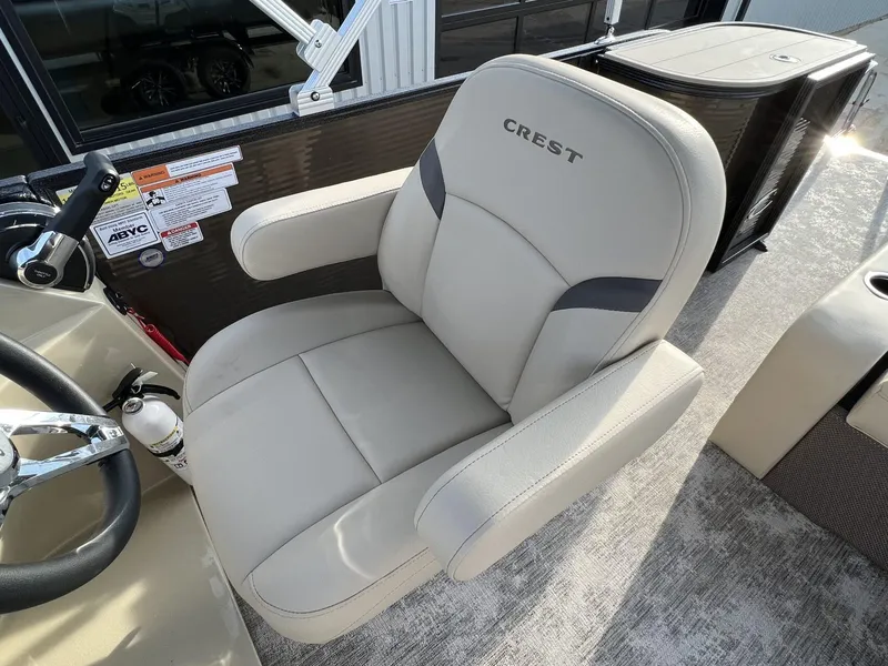 Slide: The Image of Captain's chair on 2023 Crest Classic LX 220 SLS boat, featuring sleek design and comfort. - 18