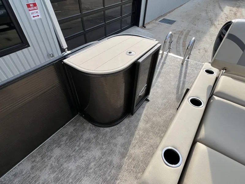 Slide: The Image of 2023 Crest Classic LX 220 SLS boat interior with seating and storage. - 19