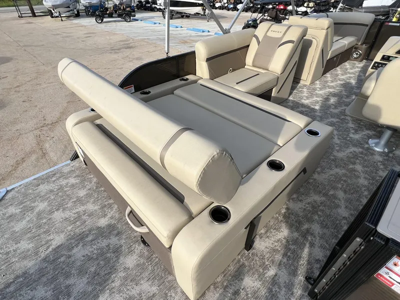 Slide: The Image of 2023 Crest Classic LX 220 SLS boat interior with beige seating and cup holders. - 20