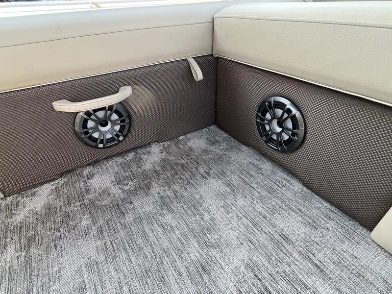 Slide: The Image of 2023 Crest Classic LX 220 SLS interior with speakers and textured flooring. - 22