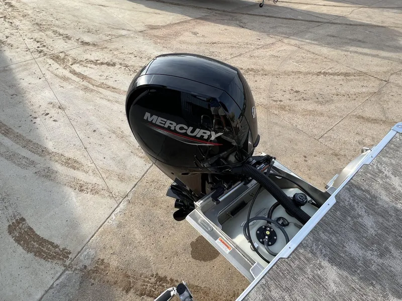 Slide: The Image of 2023 Crest Classic LX 220 SLS with Mercury outboard motor on concrete surface. - 23