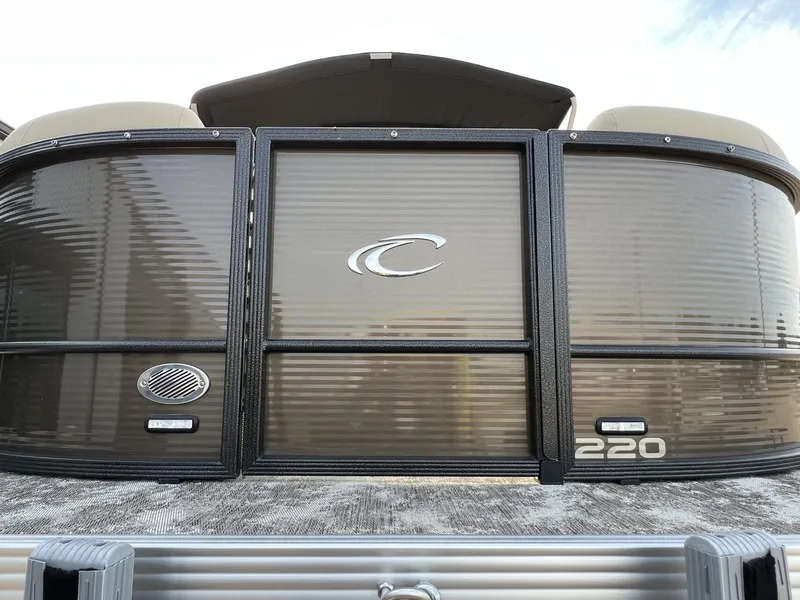 Slide: The Image of 2023 Crest Classic LX 220 SLS pontoon boat, front view with logo and model number. - 7