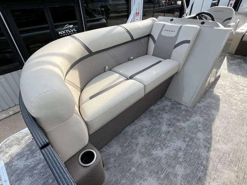 Slide: The Image of 2023 Crest Classic LX 220 SLS boat interior with plush seating and cup holder. - 8