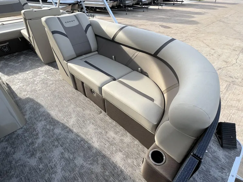Slide: The Image of 2023 Crest Classic LX 220 SLS boat interior with plush seating and cup holder. - 9