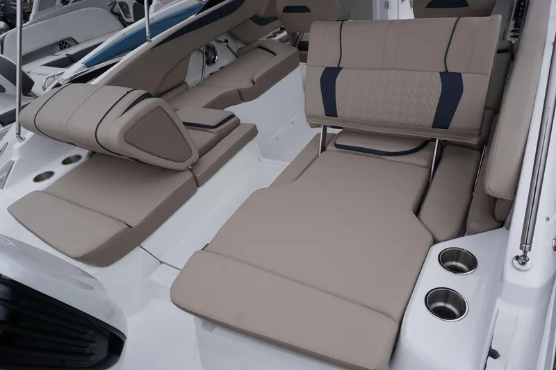 Slide: The Image of 2024 Hurricane 2600 SD boat interior with beige seating and cup holders. - 10