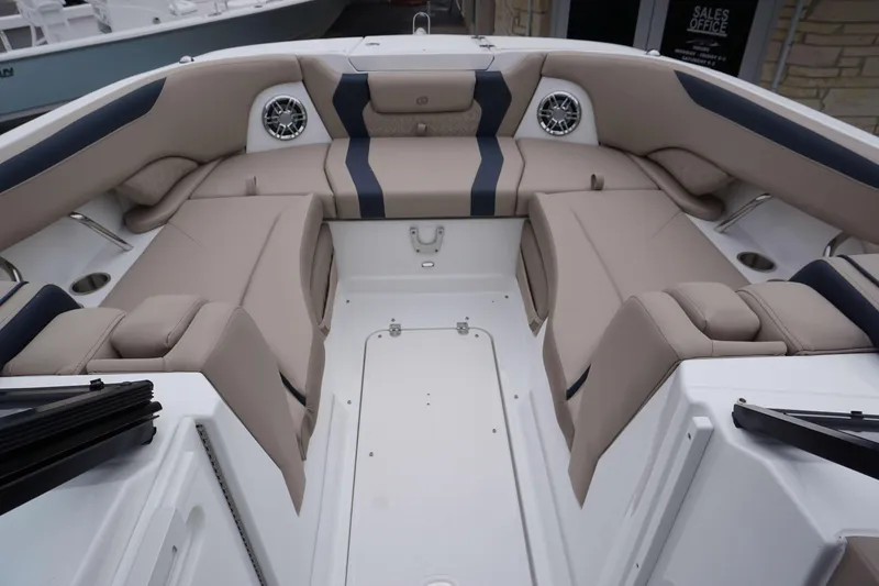 Slide: The Image of 2024 Hurricane 2600 SD boat interior with beige and navy seating. - 12