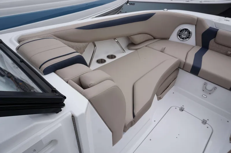 Slide: The Image of 2024 Hurricane 2600 SD boat interior with beige seating and cup holders. - 13