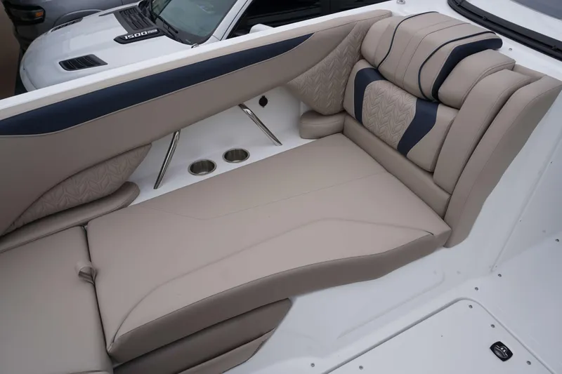 Slide: The Image of 2024 Hurricane 2600 SD boat interior with beige and navy cushioned seating. - 14