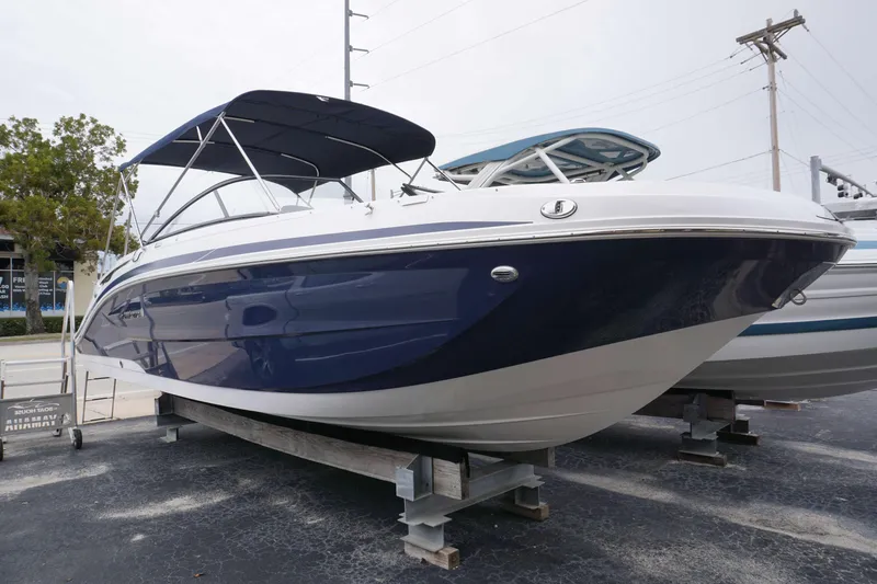 Slide: The Image of 2024 Hurricane 2600 SD boat with blue hull and canopy on display. - 17