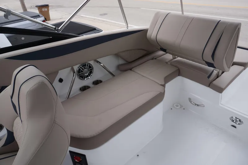 Slide: The Image of 2024 Hurricane 2600 SD boat interior with beige seating and stainless steel cup holders. - 3
