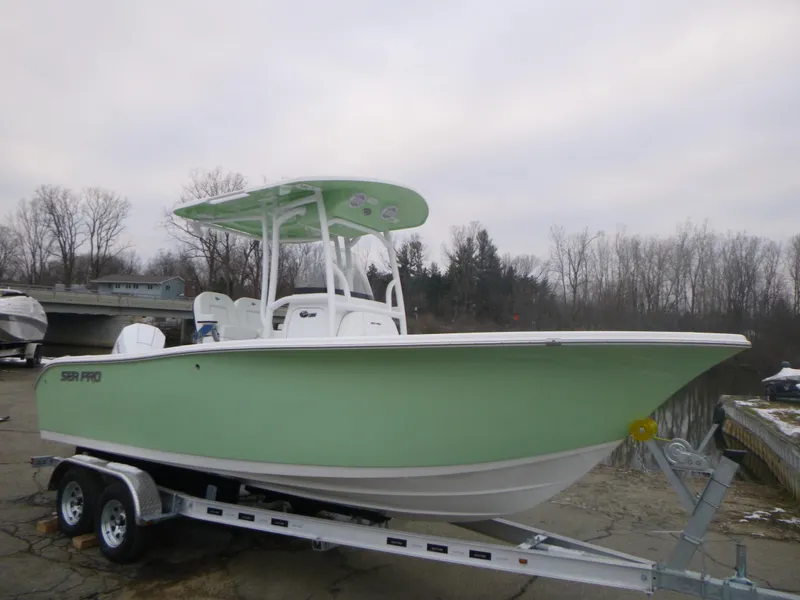 Slide: The Image of 2024 Sea Pro 222 Center Console boat on a trailer, light green hull. - 1