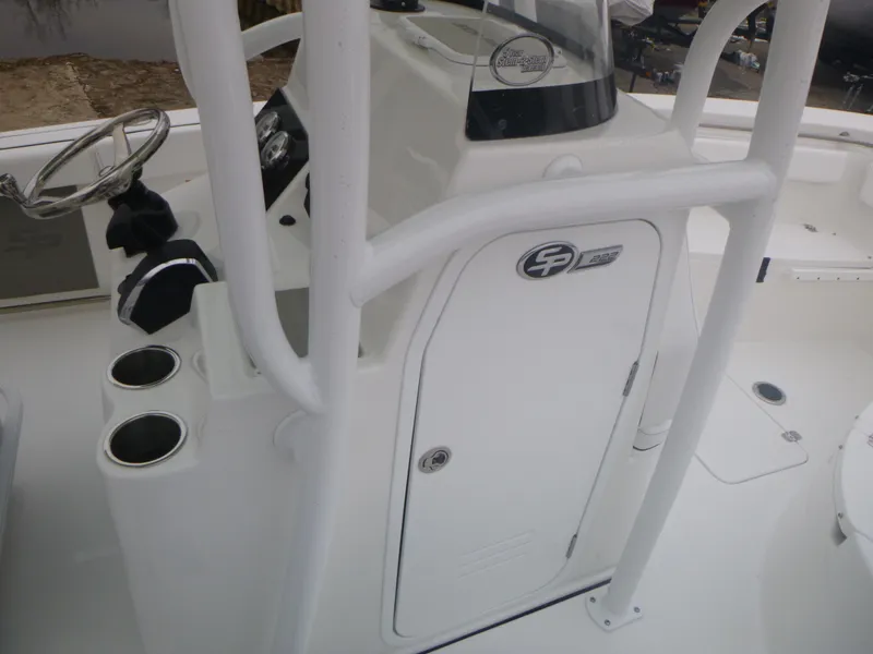 Slide: The Image of 2024 Sea Pro 222 Center Console boat interior with steering wheel and storage compartment. - 11
