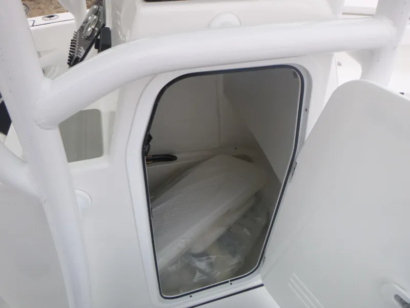 Slide: The Image of 2024 Sea Pro 222 Center Console storage compartment with open door. - 12