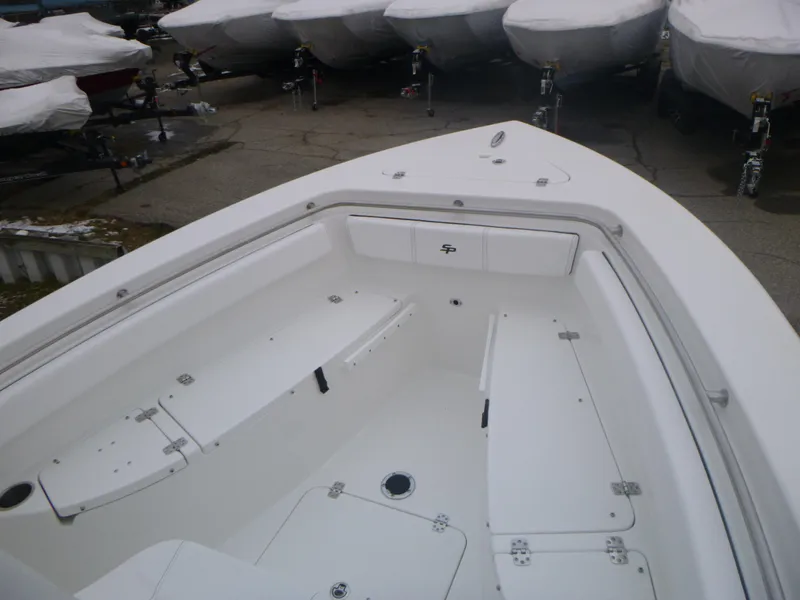 Slide: The Image of 2024 Sea Pro 222 Center Console boat interior, white seating and storage compartments. - 13