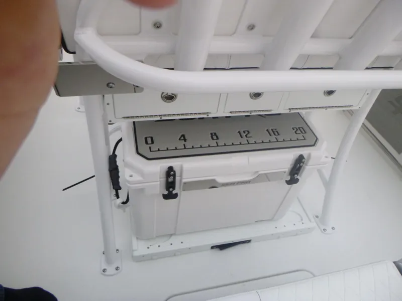 Slide: The Image of 2024 Sea Pro 222 Center Console boat with cooler and measuring scale. - 16