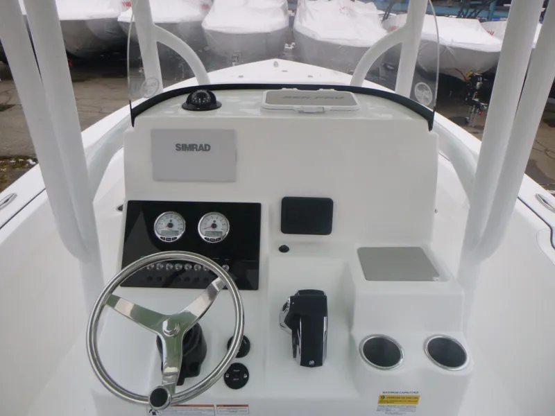 Slide: The Image of 2024 Sea Pro 222 Center Console boat dashboard with steering wheel and controls. - 7