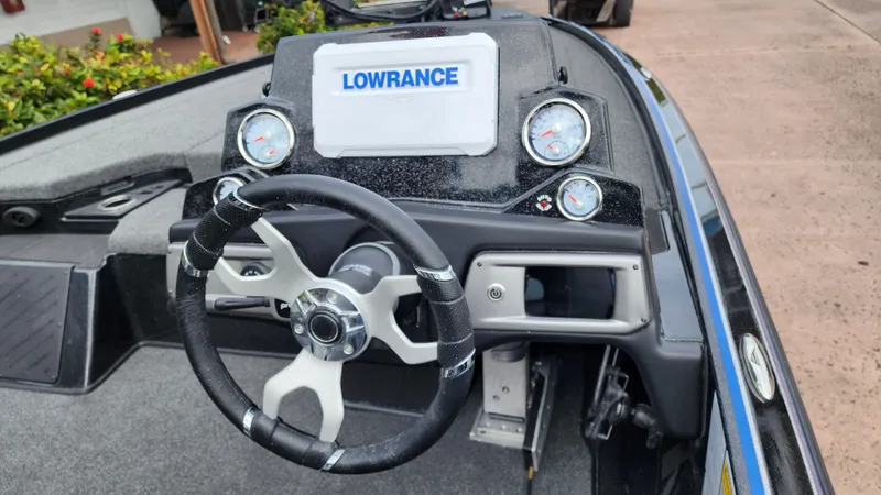 Slide: The Image of Nitro Z20 Pro 2024 boat dashboard with Lowrance display and steering wheel. - 2