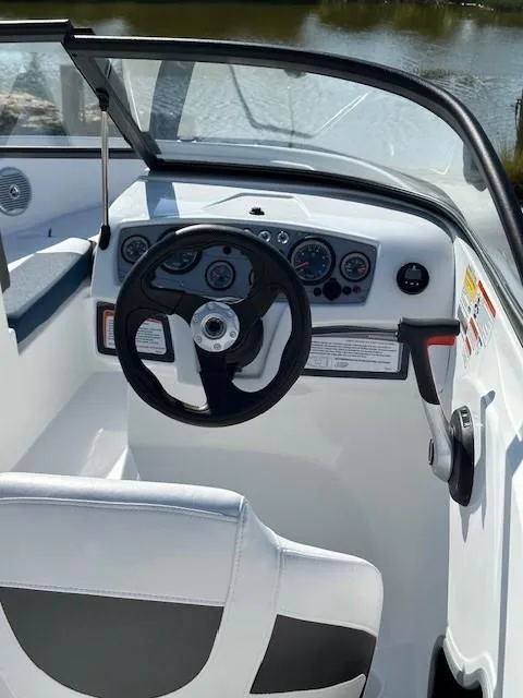 Slide: The Image of 2024 Tahoe 185 S boat cockpit with steering wheel and dashboard controls. - 4